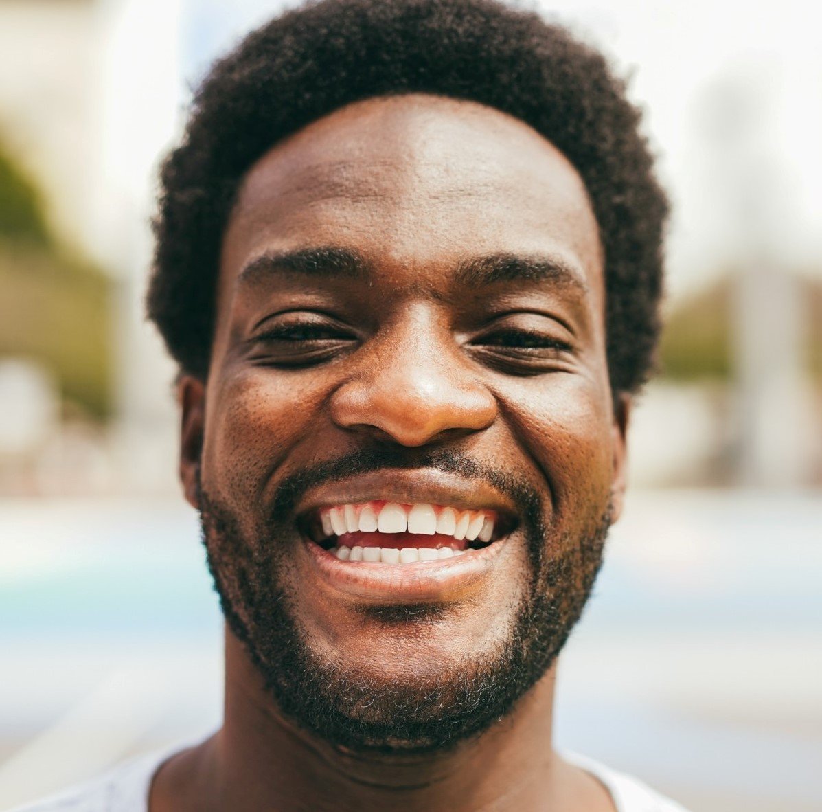 Happy African Man Smiling At Camera Inside Ba 1